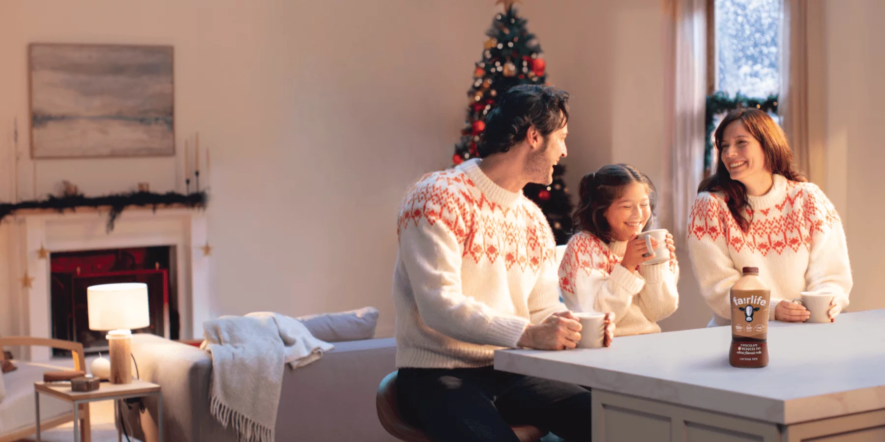 family enjoying hot chocolate with fairlife chocolate ultra-filtered milk